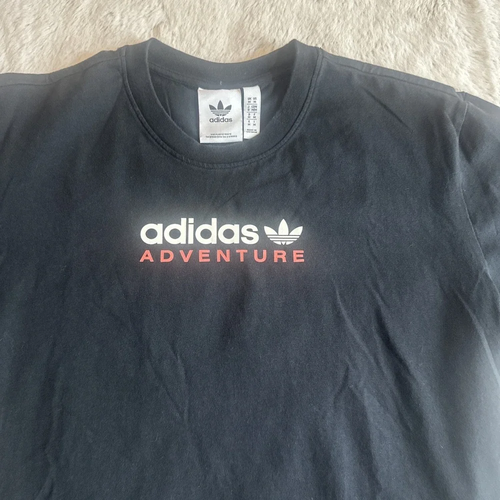 Adidas Adventure men's black graphic t-shirt‎ with Trefoil logo on chest.Size M